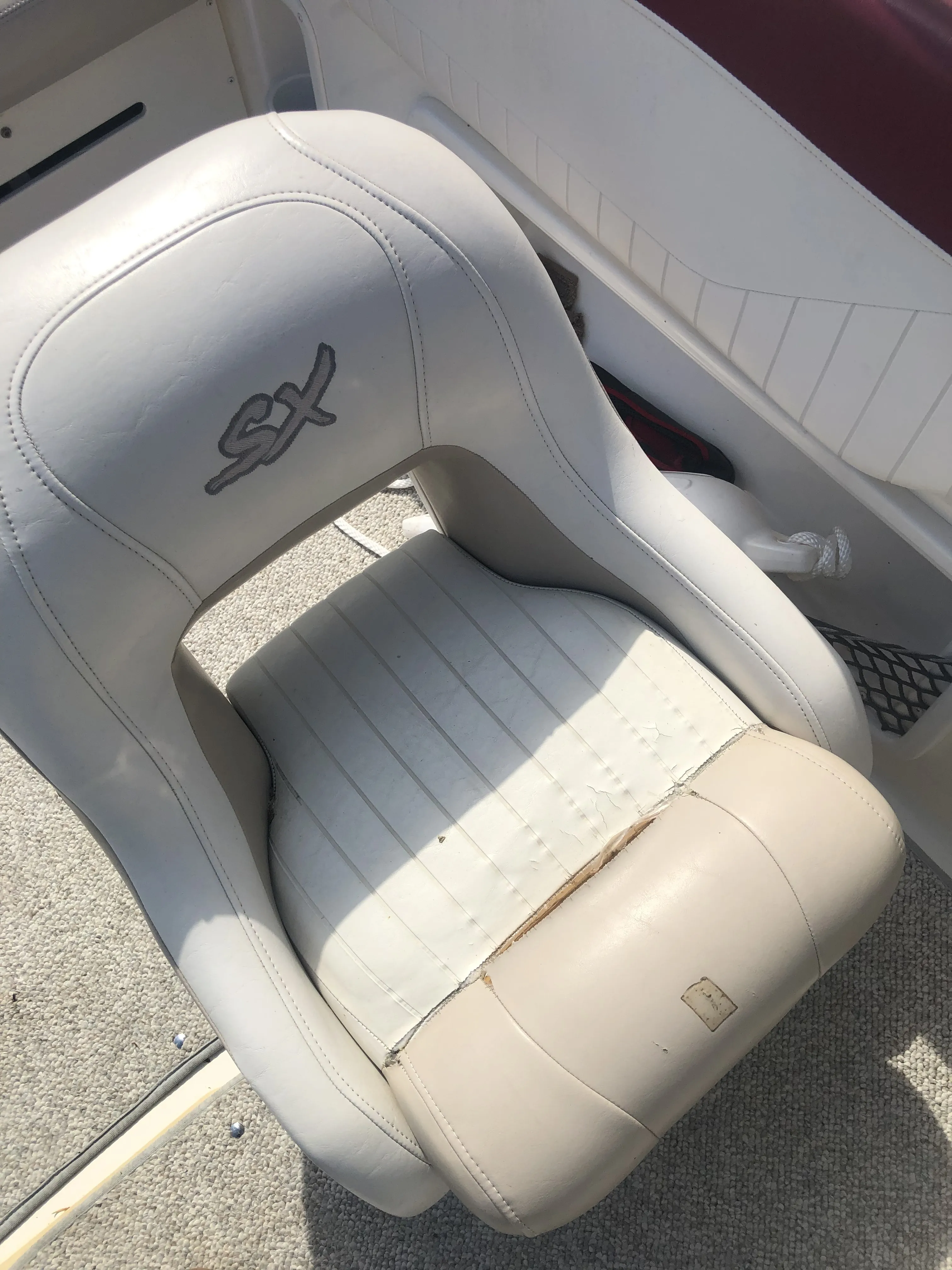 Helm seat off a boat, in for recovering
