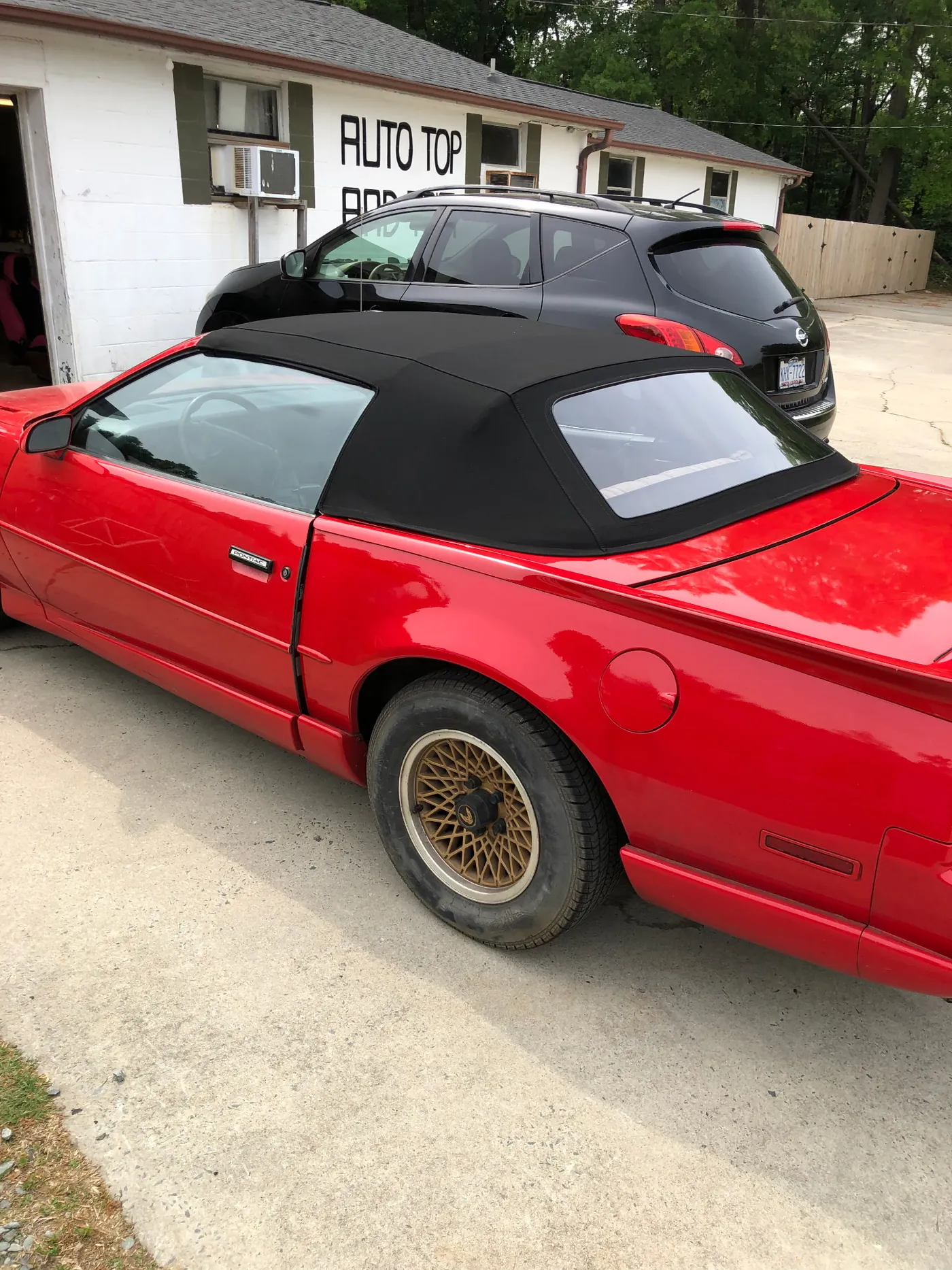 The same car finished on the driveway outside the shop