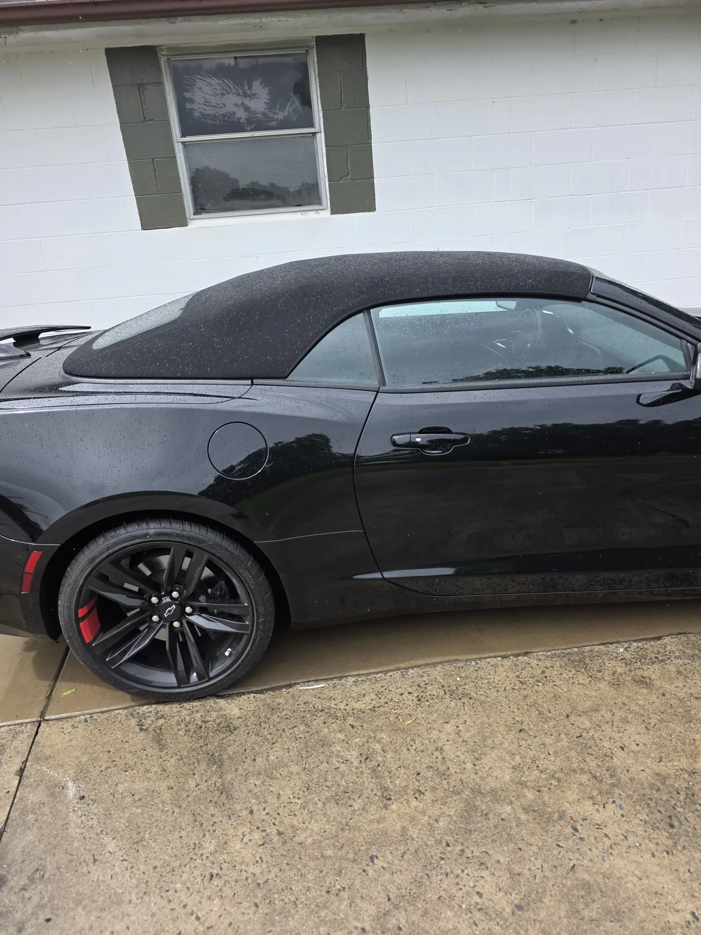 The black Camaro convertible in profile