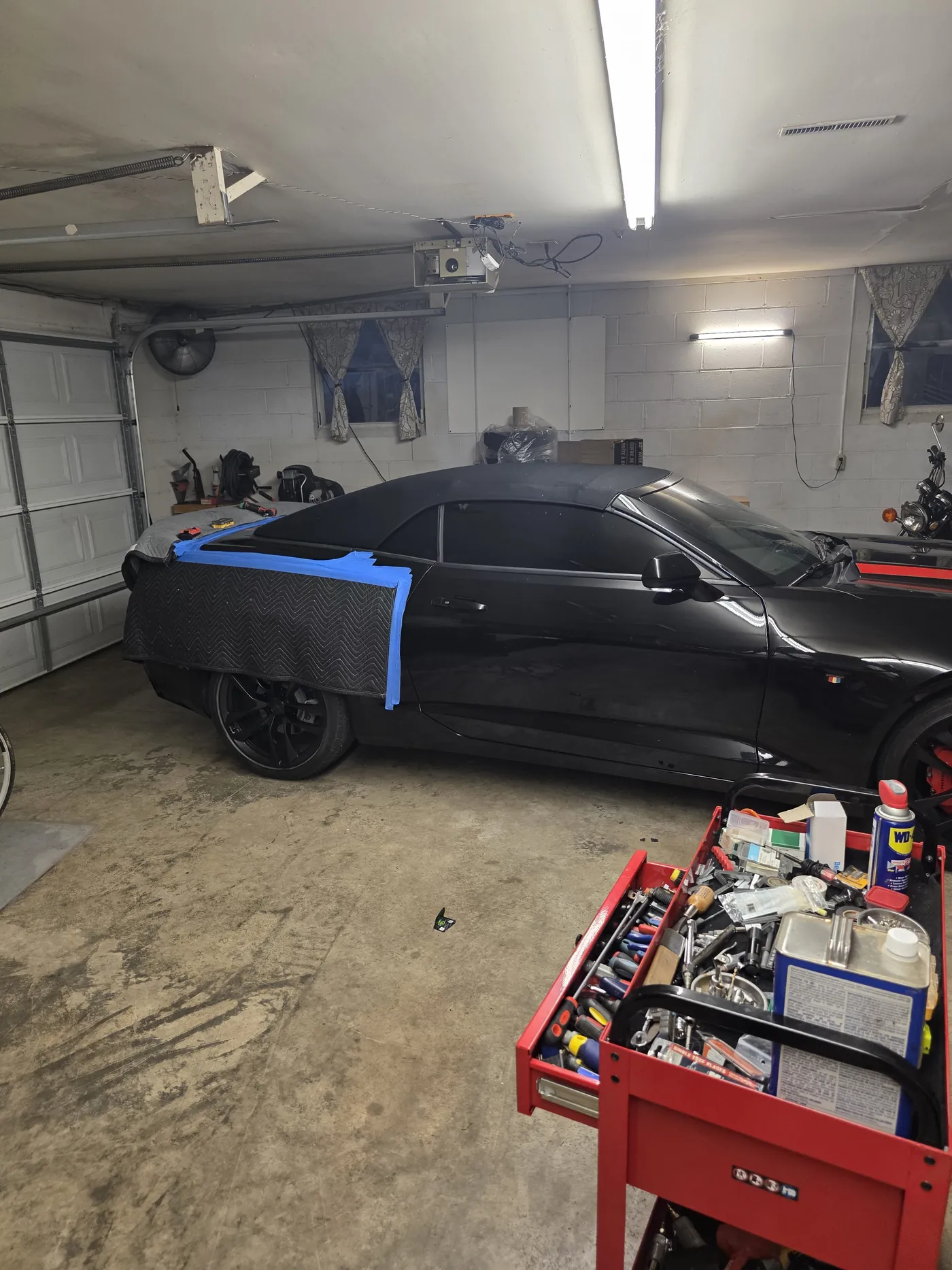 A convertible in the bay with the new top taped while it sets
