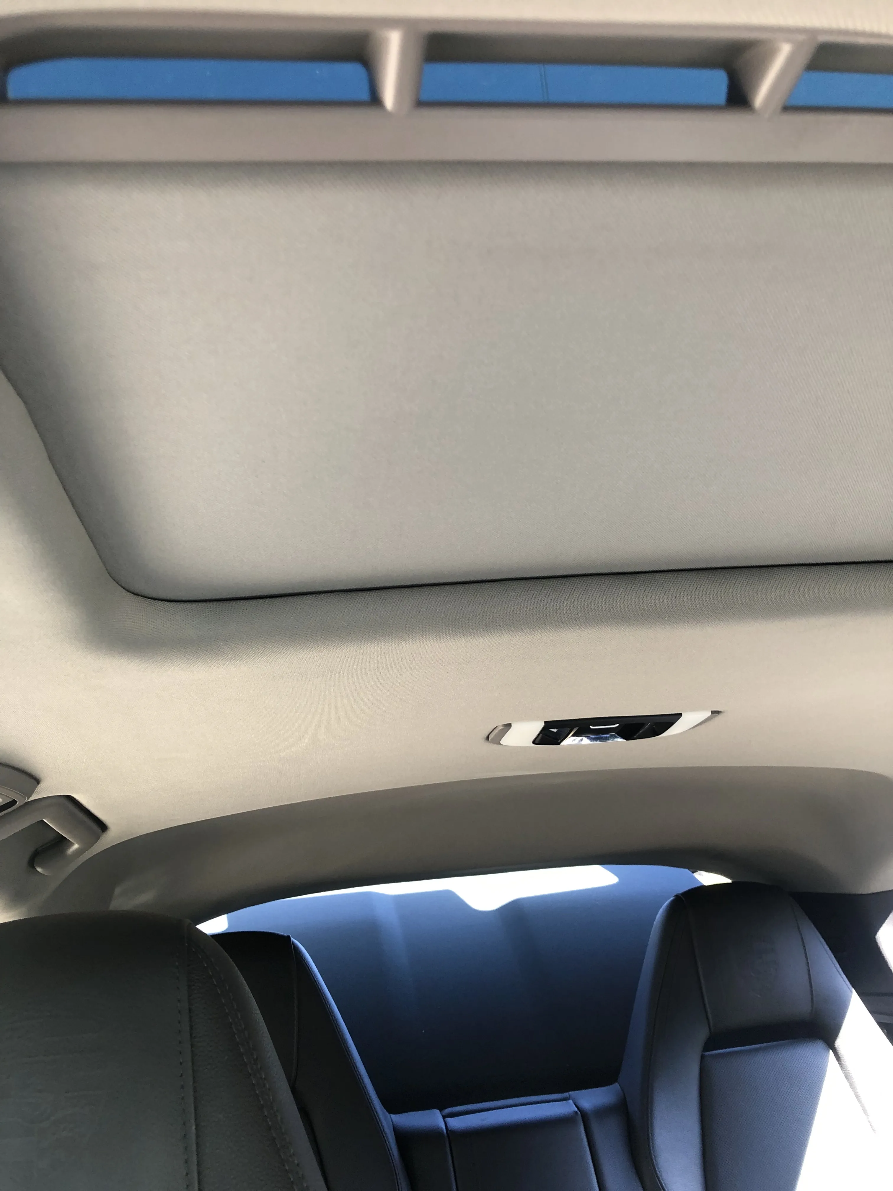 A finished headliner with the sunroof opening trimmed