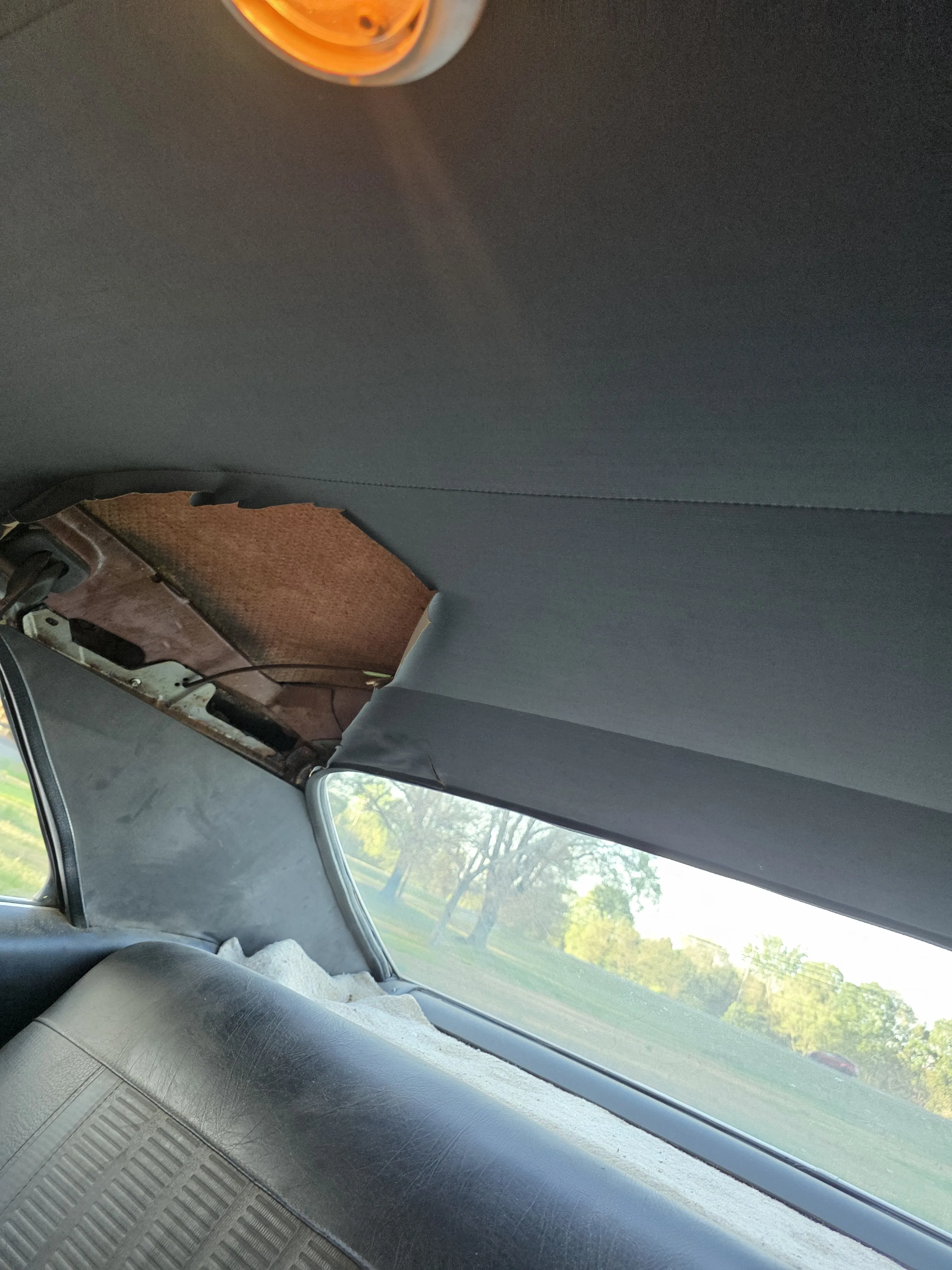 A headliner come away at the rear corner, exposing the roof structure