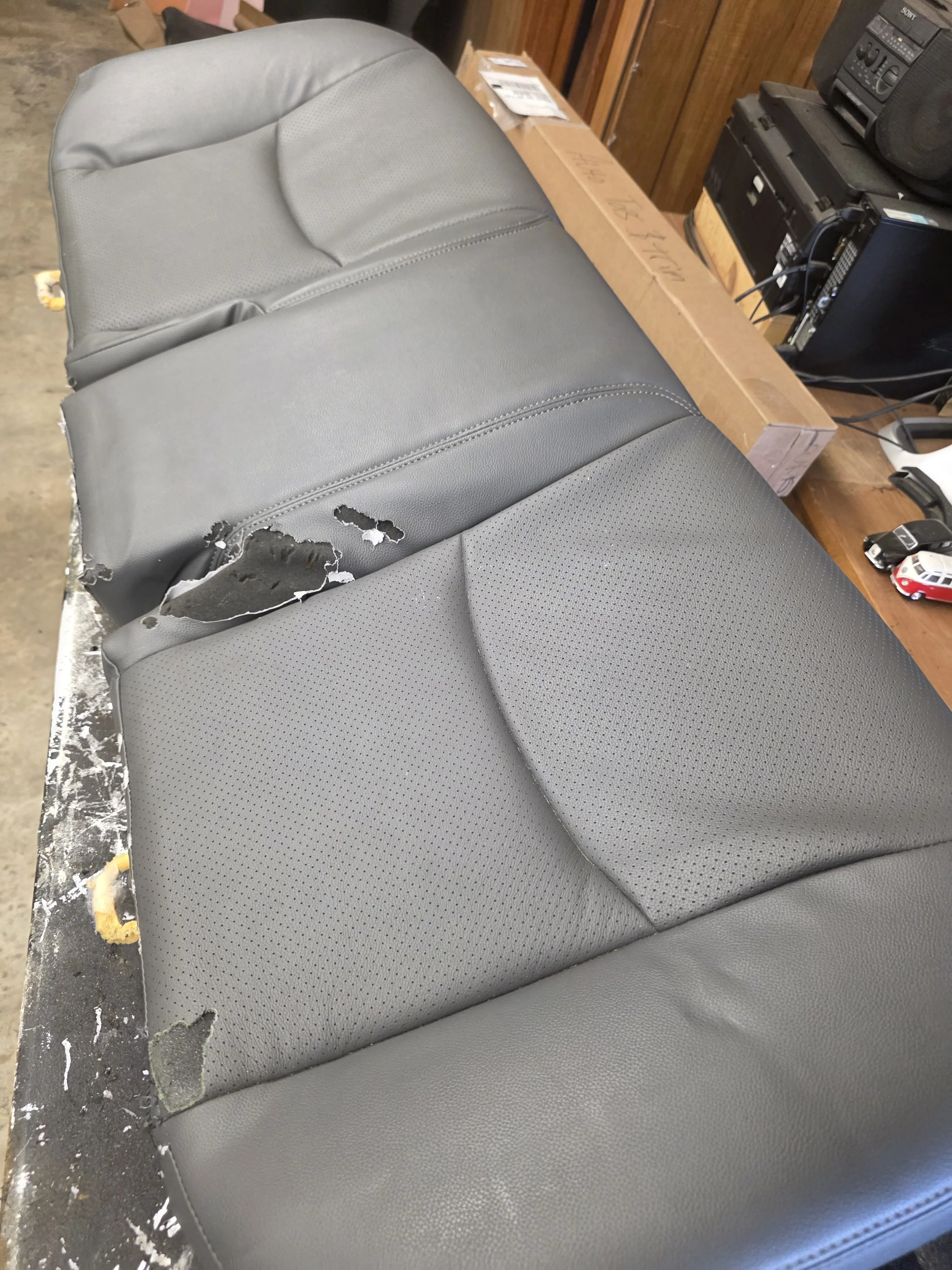 Before — grey cushion torn