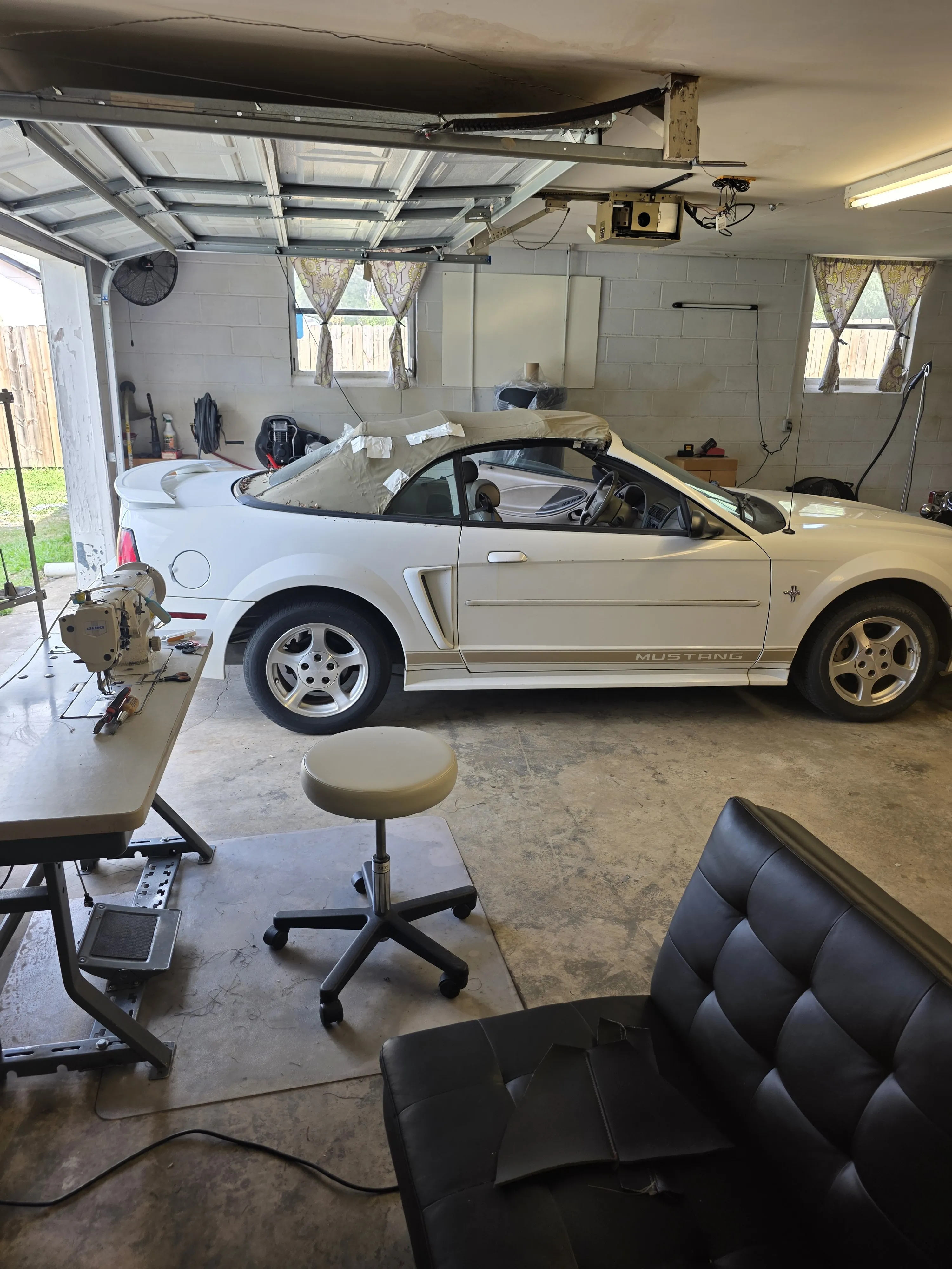 A Mustang in the bay with the roller door open