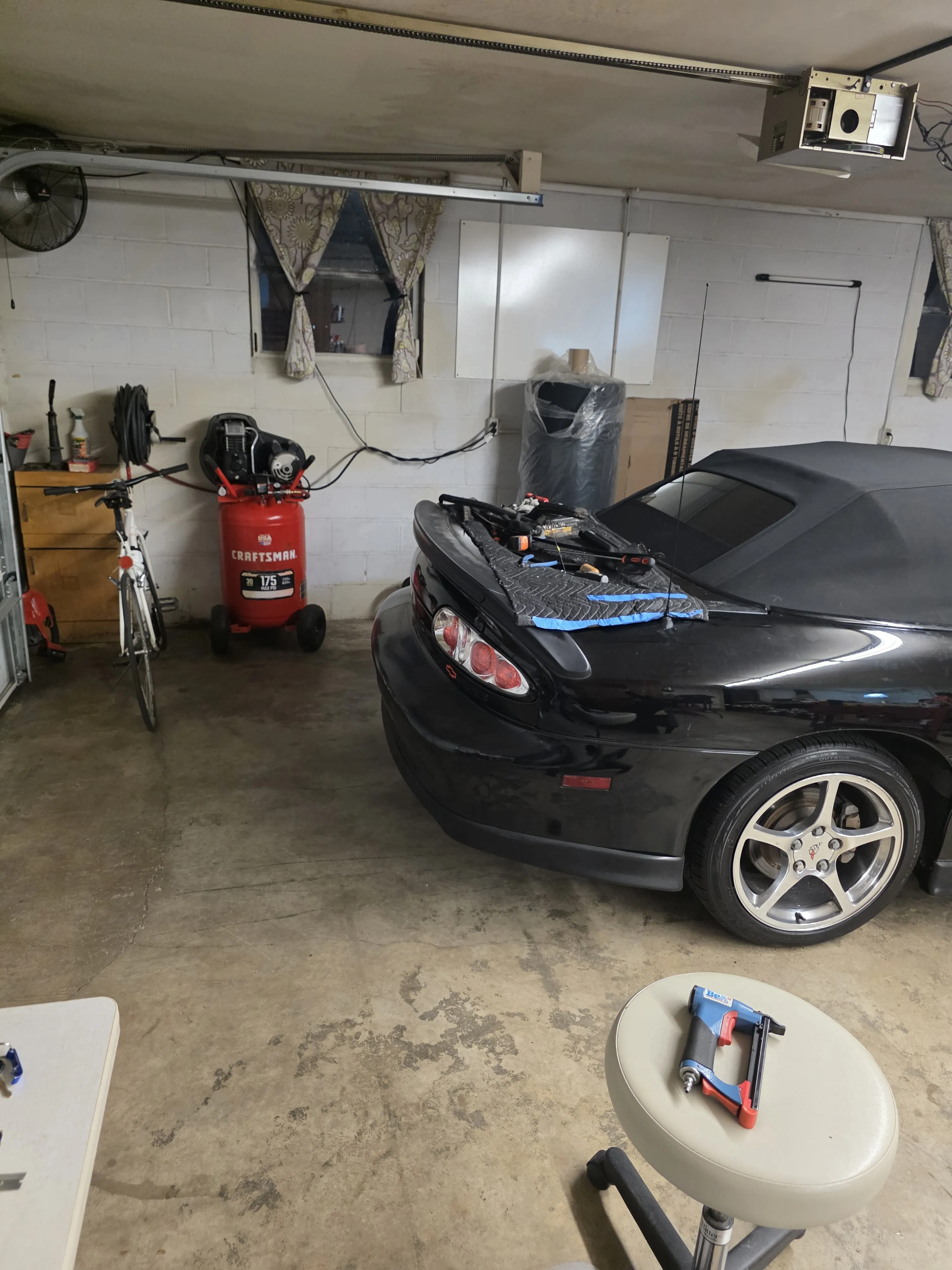 Work tables and a car in for trim work