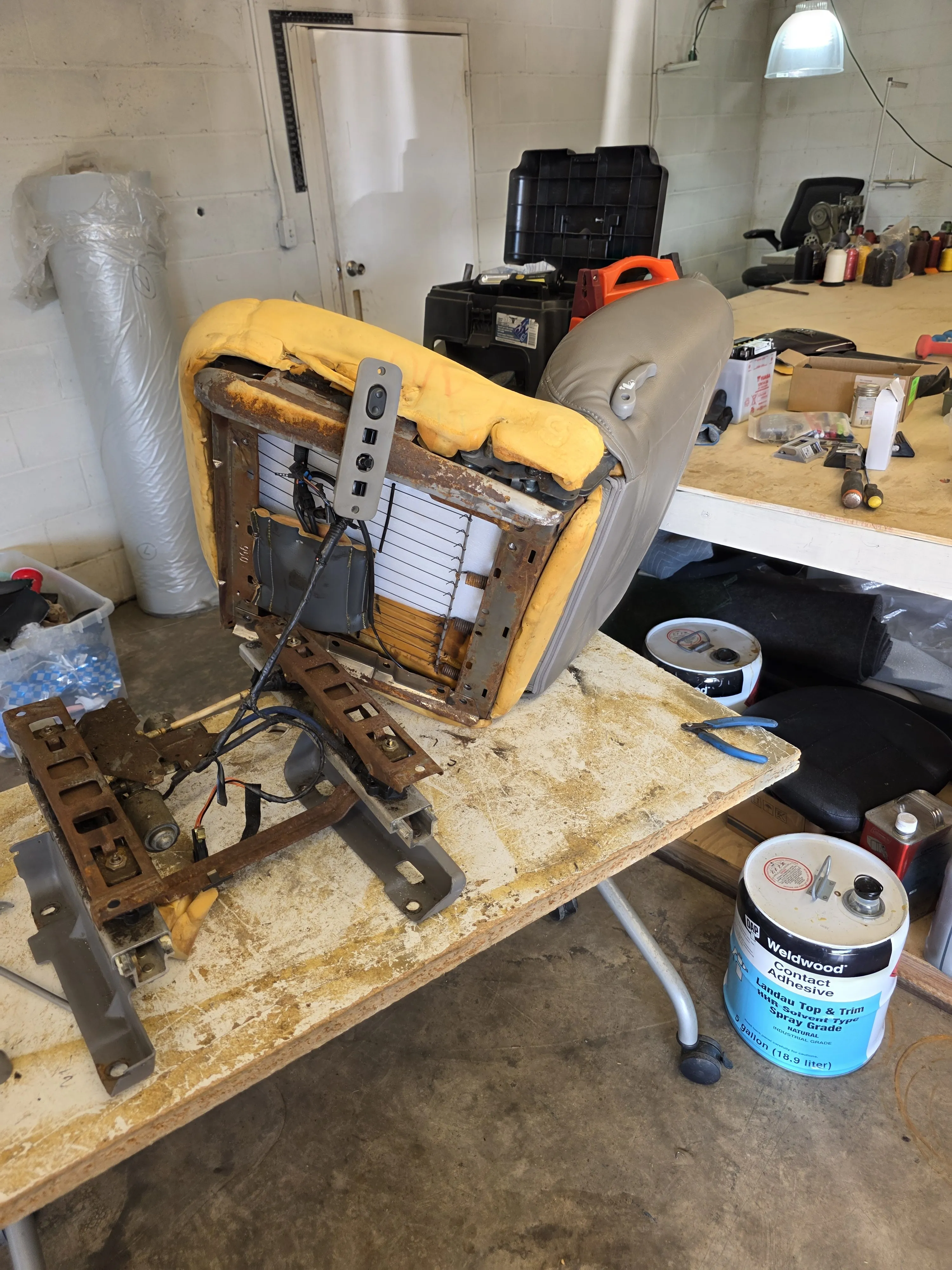 Before — seat frame stripped to foam