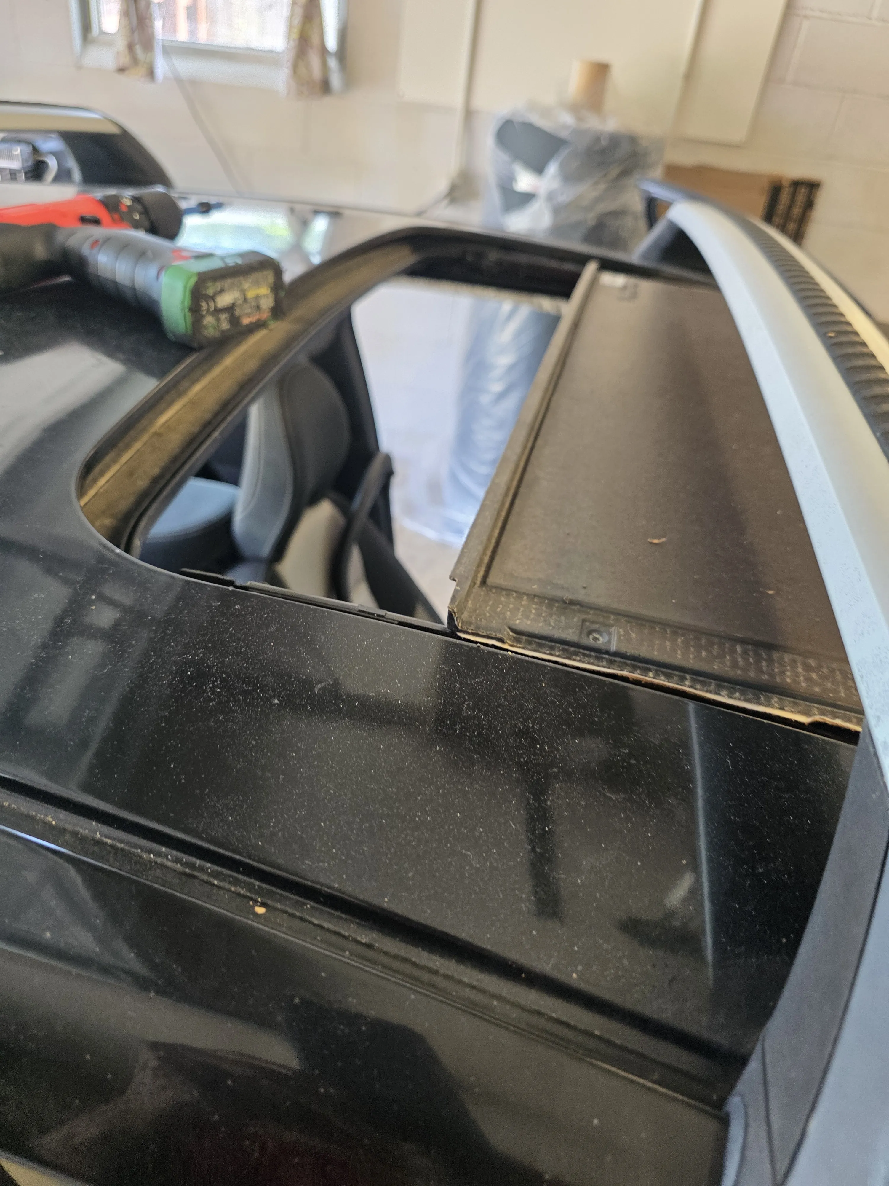 A sunroof open on a car in the shop
