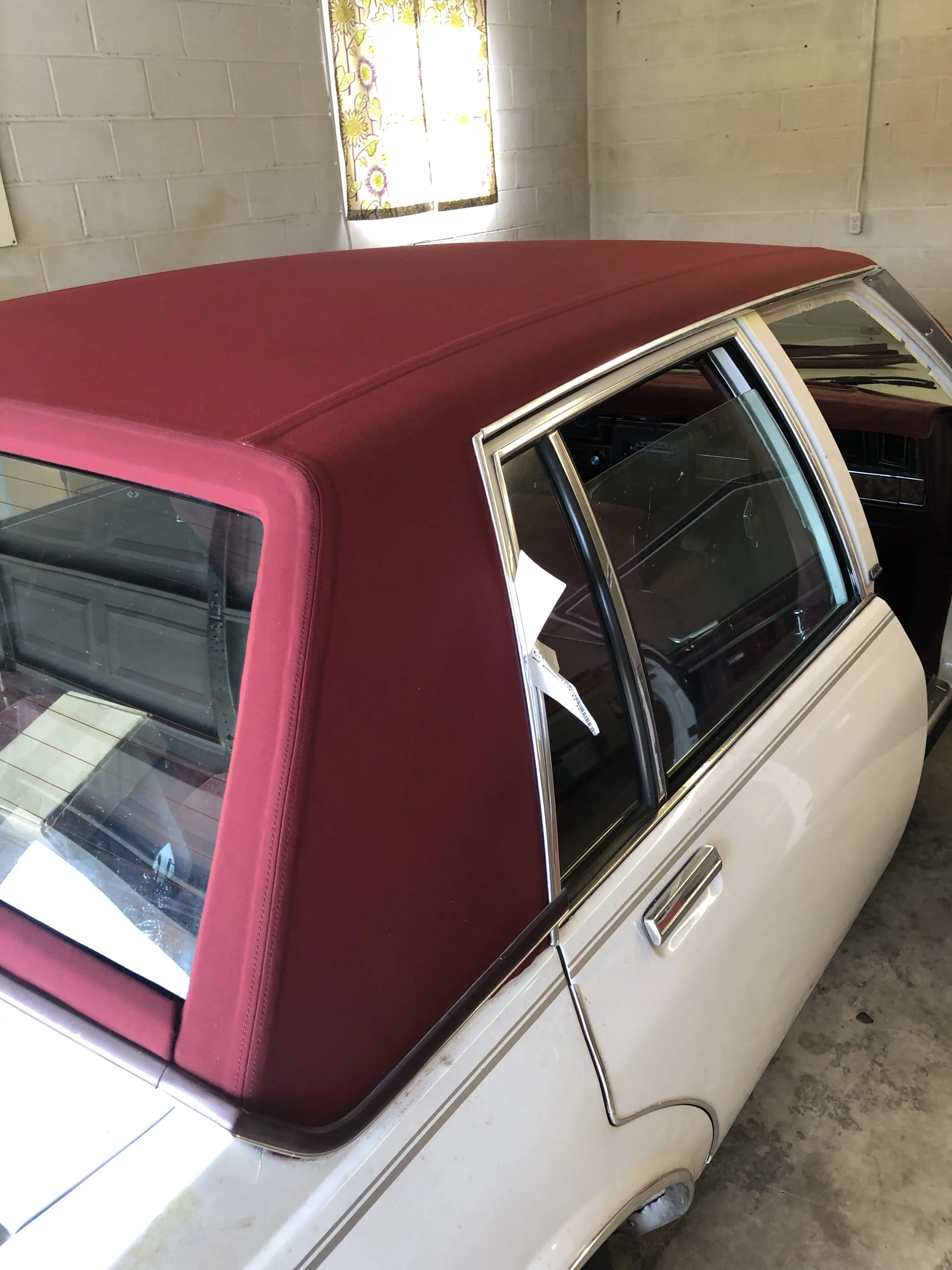 A new burgundy vinyl top fitted over the roof and rear quarter
