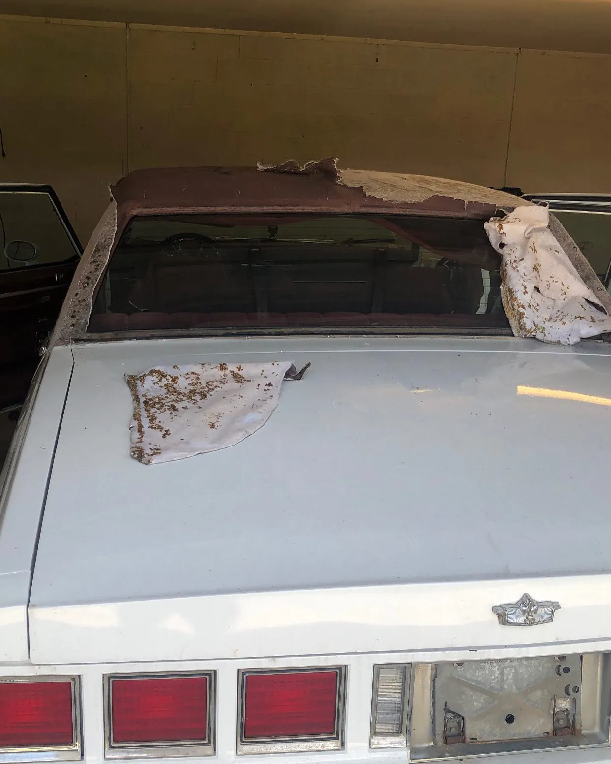 Before — vinyl top peeling at the rear